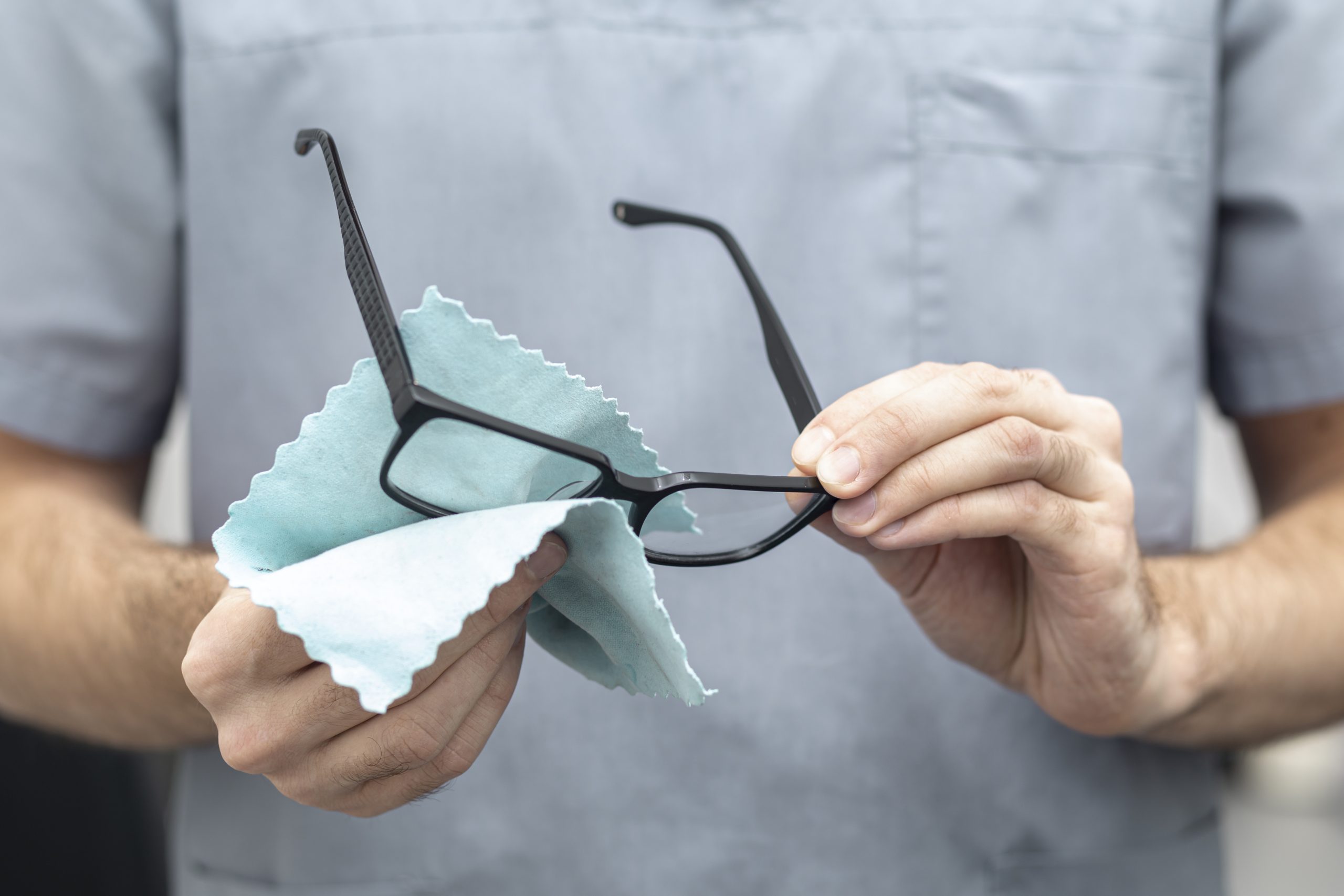 front-view-man-cleaning-his-glasses